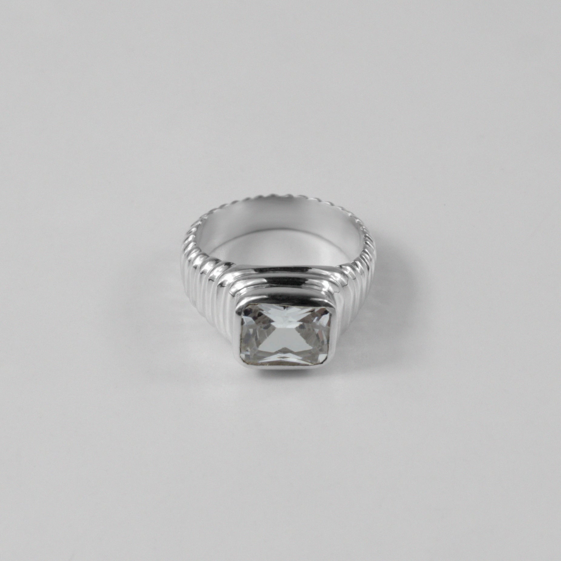 Sterling silver ring stamped '925,' featuring a unique design with faceted details, named 'Facet Fusion Ring.