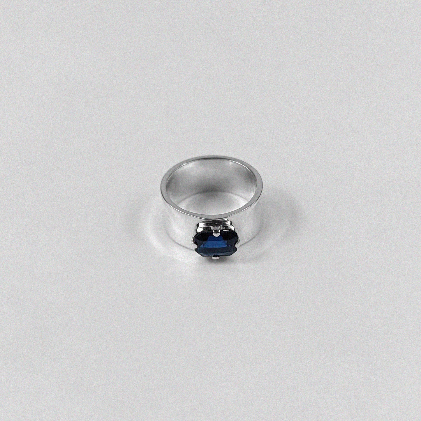 "925 sterling silver ring featuring a deep blue sapphire gemstone, named 'Midnight Sapphire Ring.'"