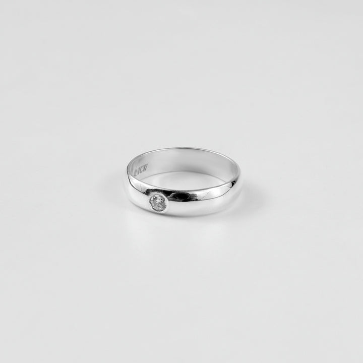 "925 sterling silver ring named 'Rosette Sparkle Band,' adorned with delicate rosette motifs and shimmering accents. Its graceful design captures the timeless charm of floral beauty, paired with a radiant touch that enhances its elegance.