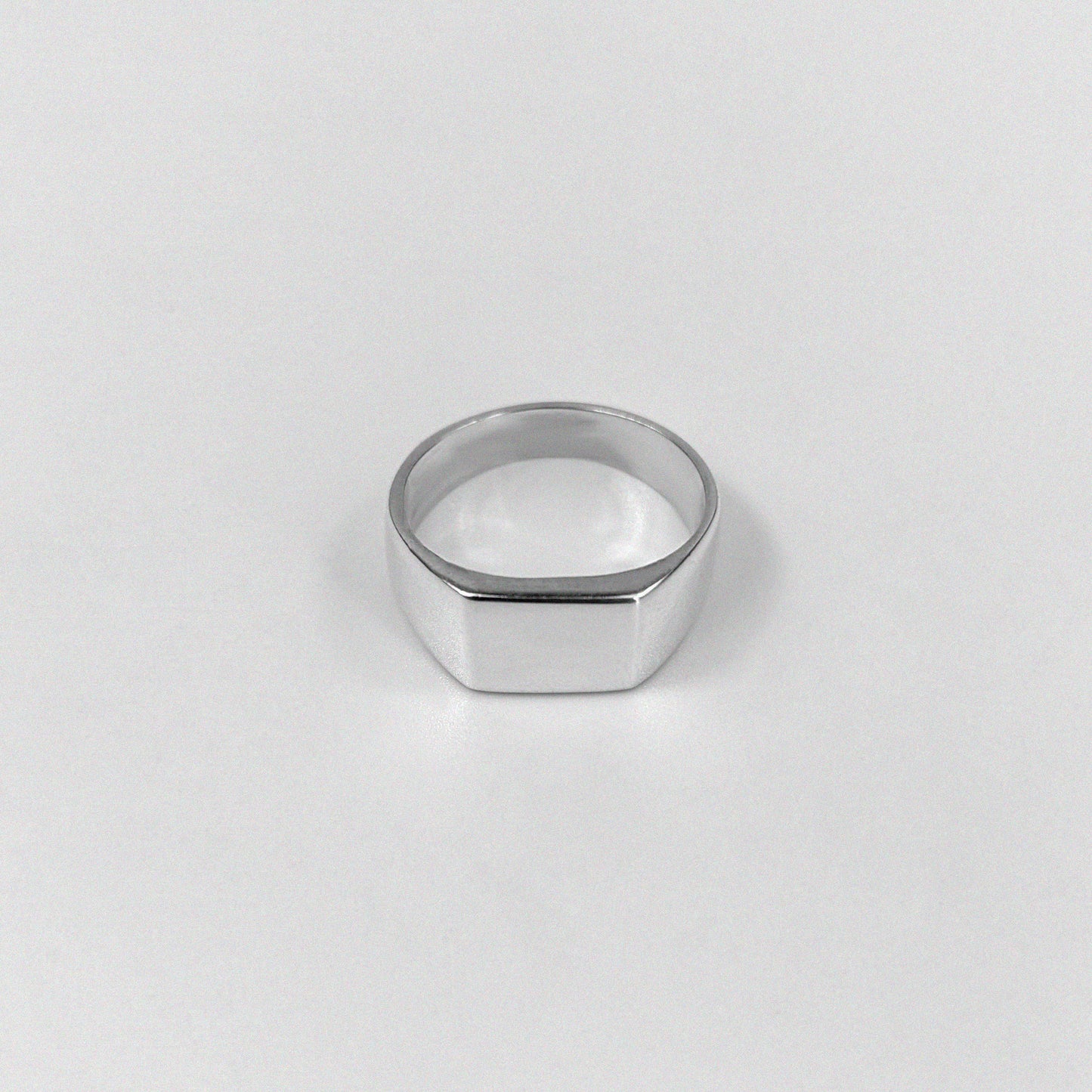 "925 sterling silver ring featuring a smooth, crest-inspired design, named 'Sleek Crest Ring.'"