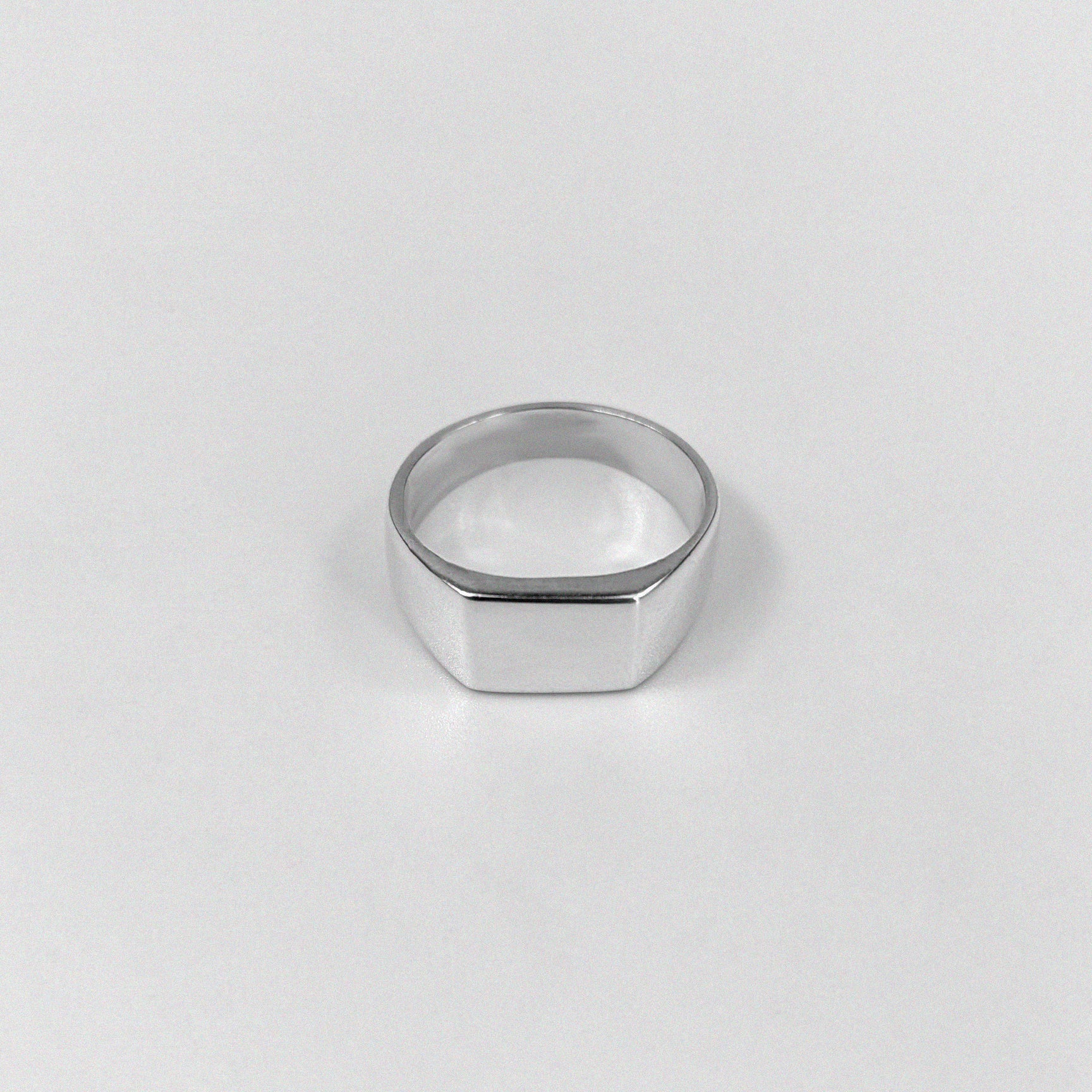 "925 sterling silver ring featuring a smooth, crest-inspired design, named 'Sleek Crest Ring.'"