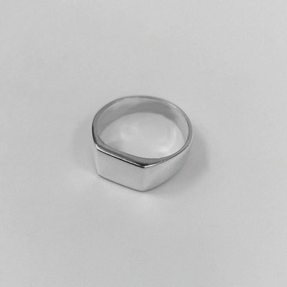 "925 sterling silver ring featuring a smooth, crest-inspired design, named 'Sleek Crest Ring.'"