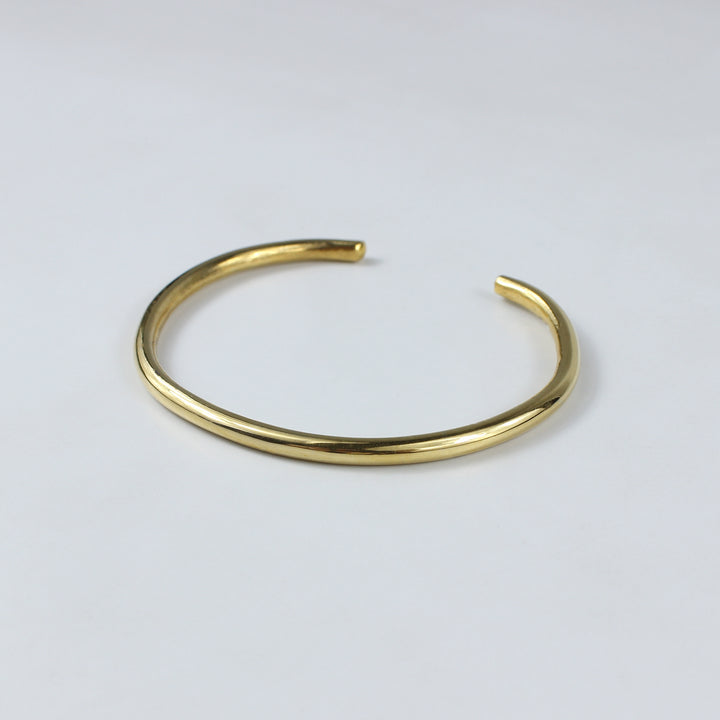 An elegant cuff bracelet made from brass and plated with 18k gold, featuring a sleek and modern design. The Vero Cuff Bracelet radiates contemporary sophistication, making it a versatile accessory for any wardrobe.